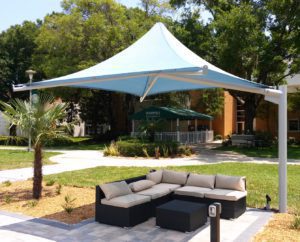 outdoor couch under a standing umbrella