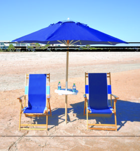 two blue chairs and an umbrella at the beach