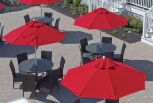 chairs and tables with red umbrellas