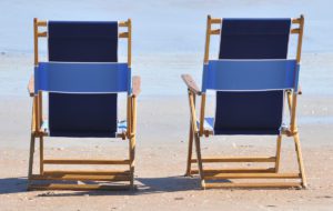 two lounge chairs at the beach
