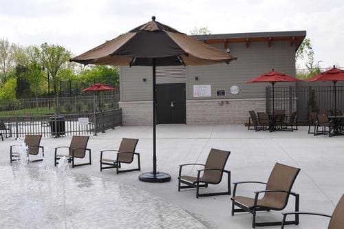 A group of chairs and an umbrella on the patio.