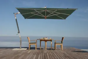 large standing umbrella over two chairs and a table