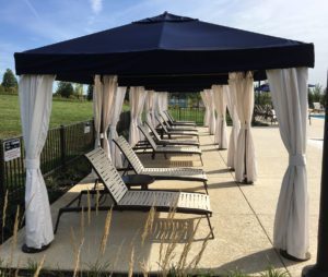 a row of lounge chairs and gazebo tents