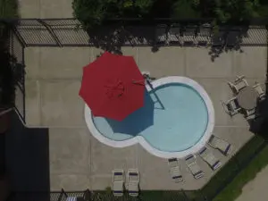 red umbrella over a small swimming pool