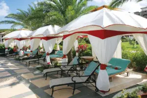 a row of gazebo tents and lounge chairs