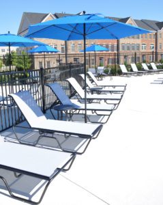 lounge chairs and blue standing umbrellas